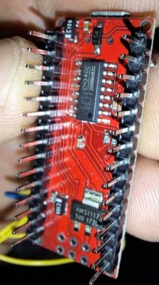 Close-up of an electronic module in hand.