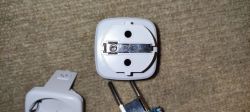 Disassembled Electronic Device with Socket and Plug View of a disassembled electronic device with a visible socket and plug on a carpet.