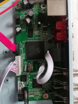 Motherboard of an Electronic Device Motherboard of an electronic device with visible electronic components and wires.