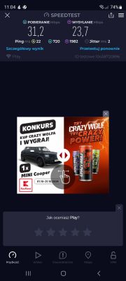 Zrzut ekranu aplikacji Speedtest pokazujący prędkość pobierania 31,2 Mbps i wysyłania 23,7 Mbps z informacjami o pingu, jitterze oraz reklamą konkursu Kaufland na dole.