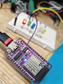 ESP32-C2 board connected to LEDs on a breadboard.