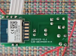 Close-up of a PCB with an electronic module and red wires.
