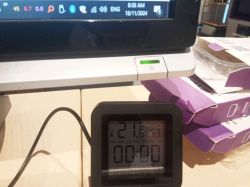 Computer screen with visible clock and LCD display showing temperature.