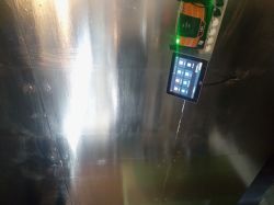 Touchscreen and electronic device mounted on a metal wall.