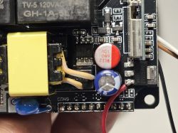 Close-up of a PCB with electronic components, including capacitors and a relay