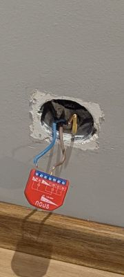 NOUS B3Z relay module connected to exposed wires in a wall electrical box
