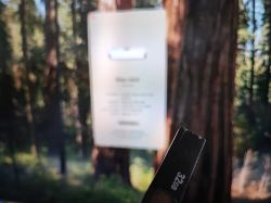 32GB USB Drive in Front of Computer Screen 32GB USB drive in front of a computer screen with a blurred forest background.