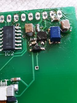 Close-up of a circuit board with a TPS unit and electronic components after soldering.
