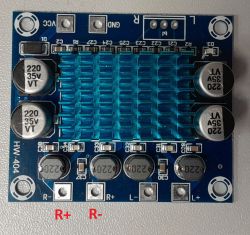 Amplifier PCB with blue heatsink; red labels show correct R+ and R- for the right channel.