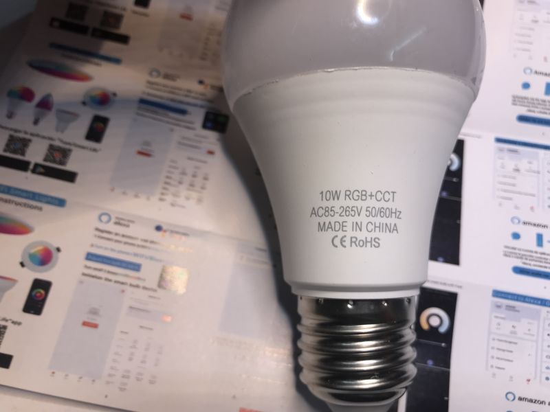 TNCE Smart E27 LED Bulb TNCE Smart E27 LED bulb lying on technical documentation.