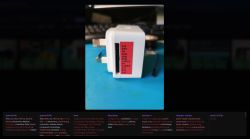 White plug-in device with a red pinout label on a blue work mat, shown in a screenshot with model tags below