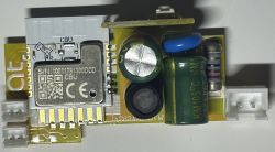 Yellow printed circuit board of a smart WiFi switch with electronic components.