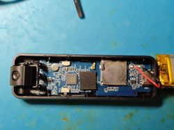 Inside of compact camera with electronics and battery Disassembled small camera interior with circuit board and microSD slot
