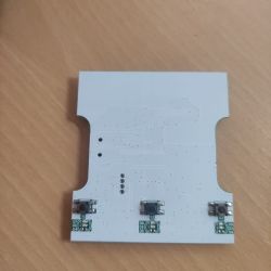 Printed circuit board with three buttons and contacts on a white background.