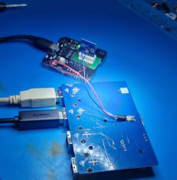 Test Module with Circuit Board Image of a module with a circuit board and cables for testing.