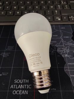 Gleco Smart Bulb Gleco smart bulb lying on a world map, with a keyboard in the background.