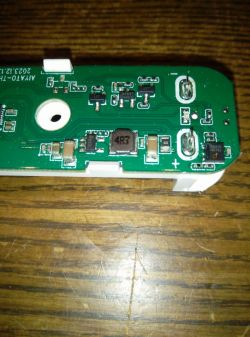 Circuit board with electronic components on a wooden background.