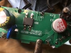 Close-up of a green PCB with an IC, capacitors, and the marking “LB1224V5-BDUSB”