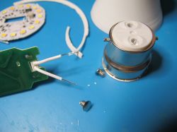Internal components of a dismantled LED bulb Disassembled LED bulb showing internal electronics and mounting components