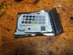 LED Controller with Remote LED strip controller with remote and wires in a plastic packaging.