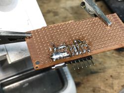 Soldering on a Printed Circuit Board Image of a printed circuit board with soldered electronic components.
