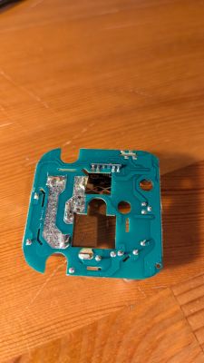 Green printed circuit board with soldered components and cutouts