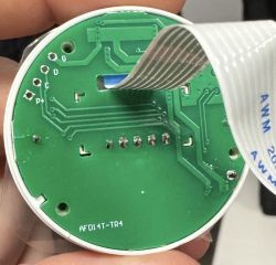 Close-up of the inside of a WiFi thermostat with an exposed PCB.