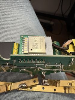 Close-up of a PCB with a Tuya T1-U-HL module under a metal shield showing a QR code