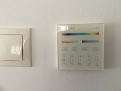 Mi-Light lighting control panel next to a switch.