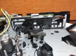 Wnętrze mechanizmu magnetofonu z widocznymi elementami napędu i elektroniki.
