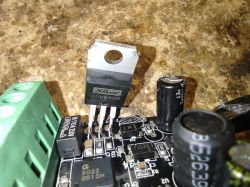 Close-up of a dimmer circuit board with visible markings on components.
