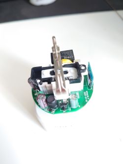 Interior of an electronic device with PCB An opened electronic device housing with visible PCB components and elements.
