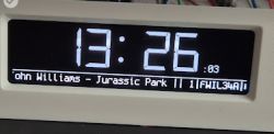 LED display showing the time 13:26 and information about the playing music.
