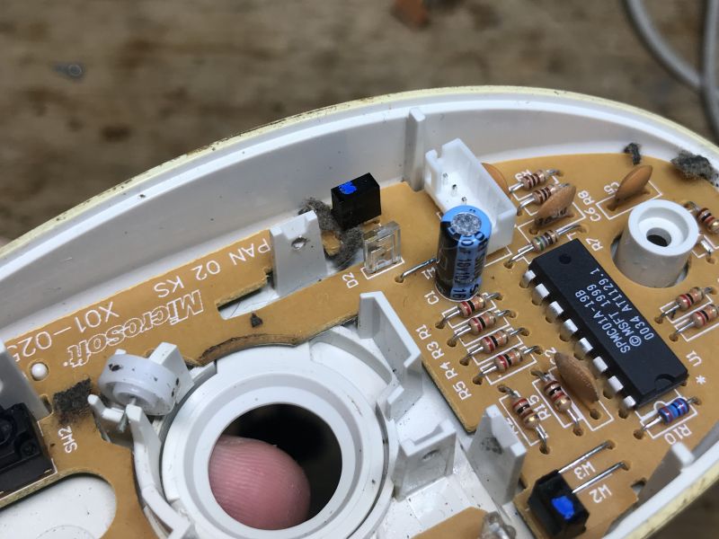 Interior of an Old Ball Mouse Interior of an old ball mouse with visible SPMC01A-19B chip and electronic components.