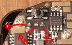 Close-up of a PCB with manually labeled UART pins: Rx, Tx, and GND.