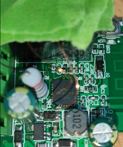 Close-up of a circuit board with soldered copper wires and electronic components.