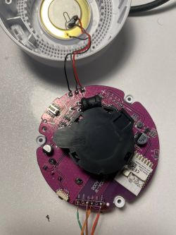 Interior of a smoke detector with a visible circuit board.