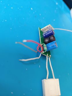 Circuit Board with Capacitors and Wires Electronic circuit board with components on a blue surface