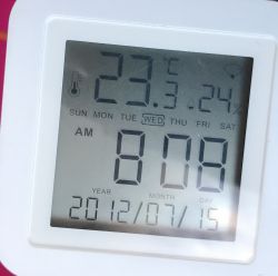Digital Clock with Thermometer Digital clock displaying temperature, date, and time.
