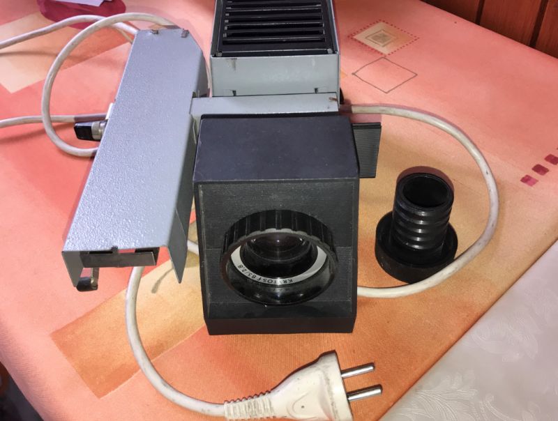 Old Slide Projector Old slide projector with plug on a table.