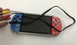 X12 handheld game console with blank screen and connected AV cable with RCA plugs and a 3.5 mm jack