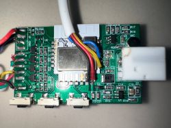 Close-up of a green printed circuit board with connected colored wires and electronic components.