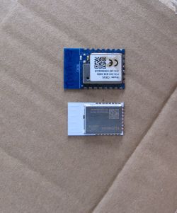 Two electronic modules on a cardboard background, including one labeled E103-W08A.