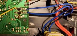 Image of a circuit board with two diodes connected in parallel, using wires in different colors.