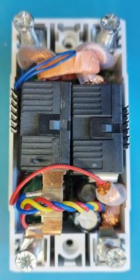 Close-up of the interior of an electronic device with wires and components.