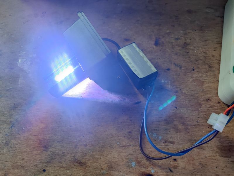 LED Lamp Test on Wooden Surface LED lamp illuminating a wooden surface.