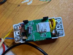 Electronic module with a PCB, screw terminals, and wires on a wooden tabletop