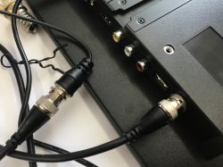 Monitor connectors: BNC, RCA jacks, and two USB ports, with a BNC cable plugged in