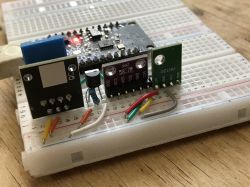 Dev board with AHT20 sensor on a breadboard with connected wires.
