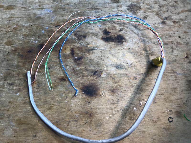 Colored Ethernet Wires on Bench Several colored Ethernet wires on a workbench.